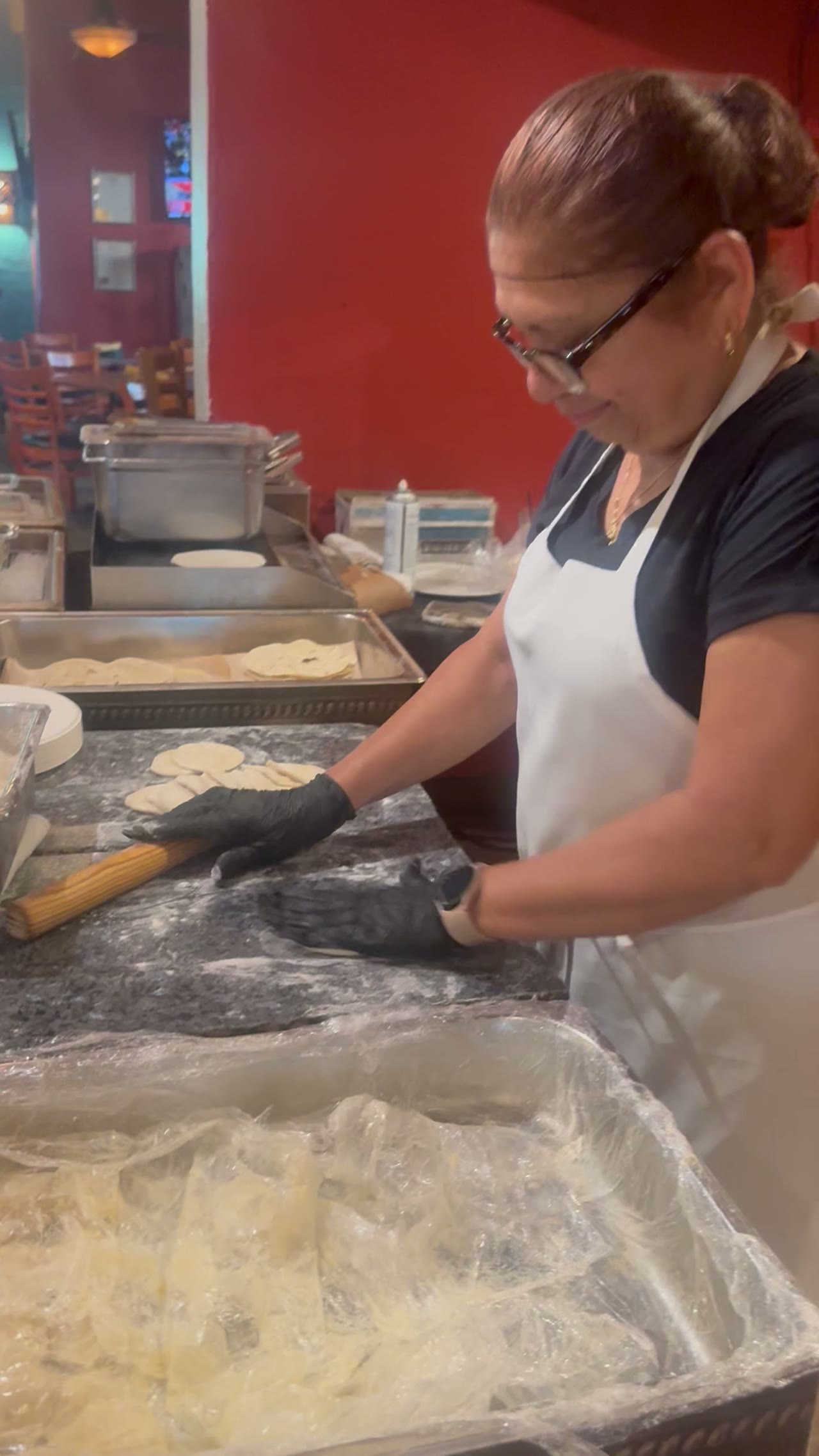 Our tortilla maker pressing fresh tortillas on the griddle